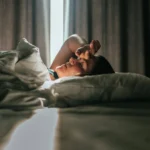 Woman awaking after sleeping well in a nice sleeping room.