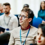 Business Conference Attendee Listening During Presentation