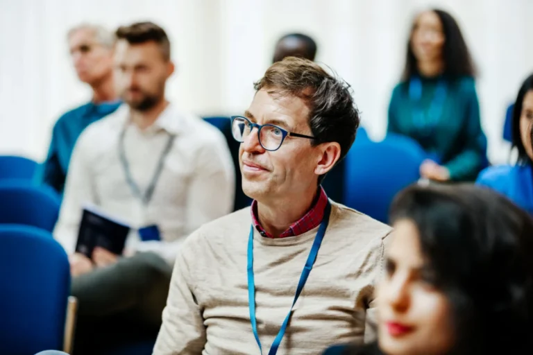 Business Conference Attendee Listening During Presentation