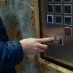 Using,An,Elevator:,A,Person,Pressing,The,Close,Door,Button