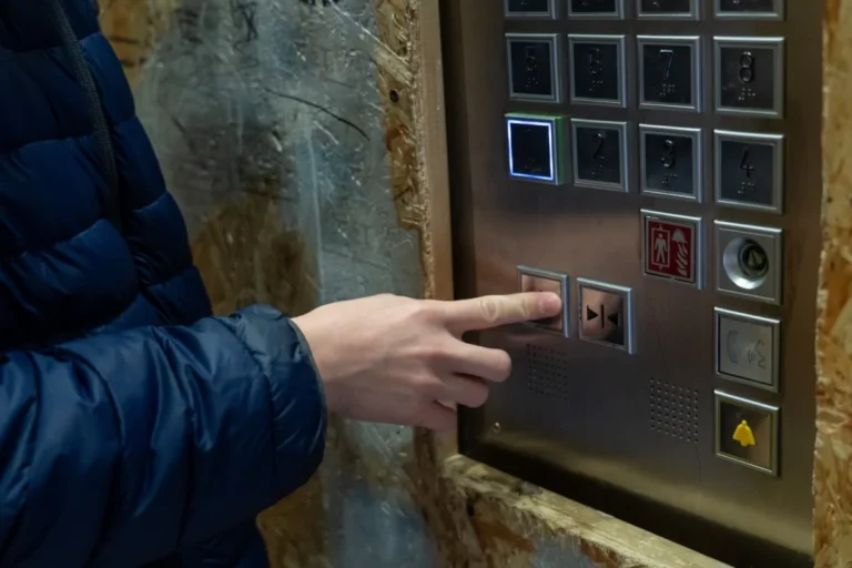 Using,An,Elevator:,A,Person,Pressing,The,Close,Door,Button
