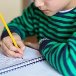child writing cursive