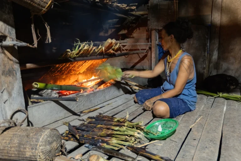 Mentawai woman cooking in the kitchen in the traditional house in the village on Siberut island West Sumatra Indonesia