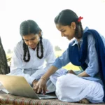 School girls using laptop